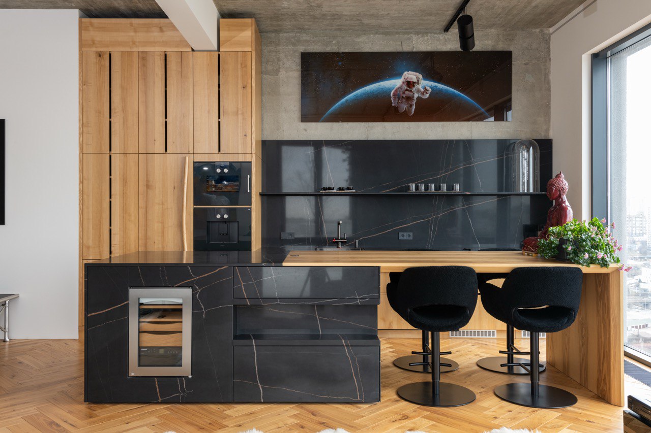 Remodeled kitchen with oak cabinetry, stone island and integrated appliances